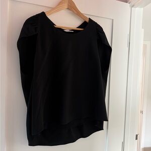 The row sleeveless cape top